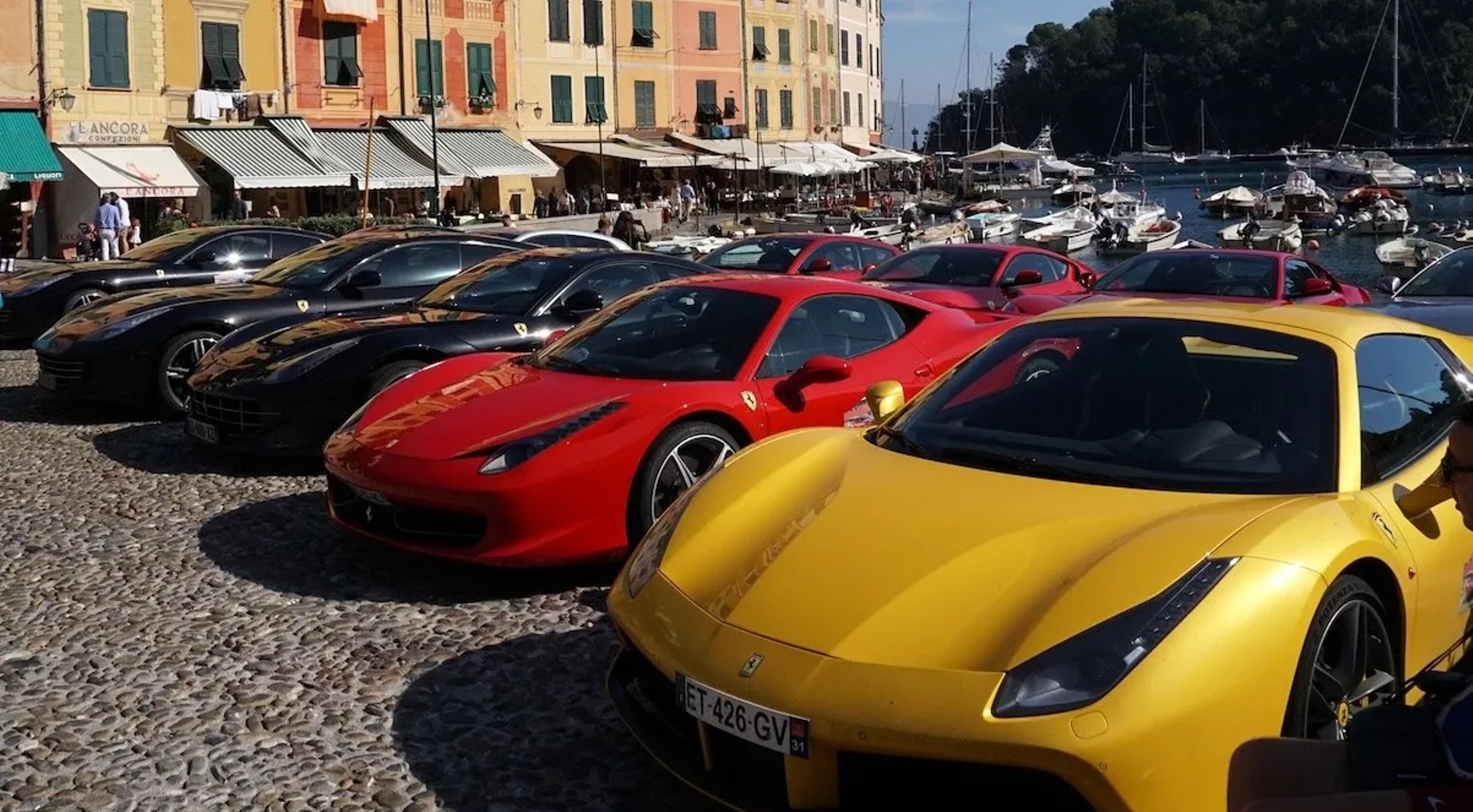 Σειρά από πολυτελείς Ferrari, κόκκινες, κίτρινες και μαύρες, παρκαρισμ…
