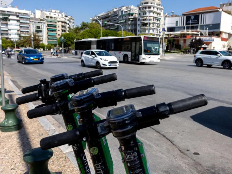 Πατίνια παρκαρισμένα σε πεζοδρόμιο πόλης δίπλα σε πολυσύχναστο δρ…
