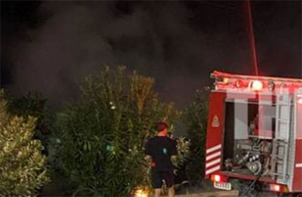 Πυροσβεστικό όχημα και πυροσβέστης σε νυχτερινή επέμβαση για φωτι…